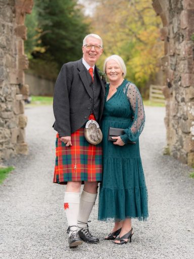 Kilt Waist Alteration - Finished Fit Customer wearing his kilt after a waist extension and apron adjustment, standing with his wife