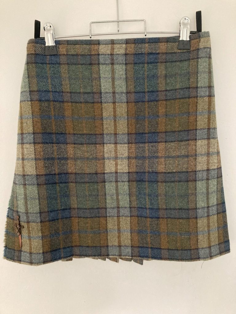 Kilt waist size adjustment with buckle repositioning - Glasgow service Waist adjustment on tartan kilt showing repositioned buckles - Glasgow kilt alteration service.