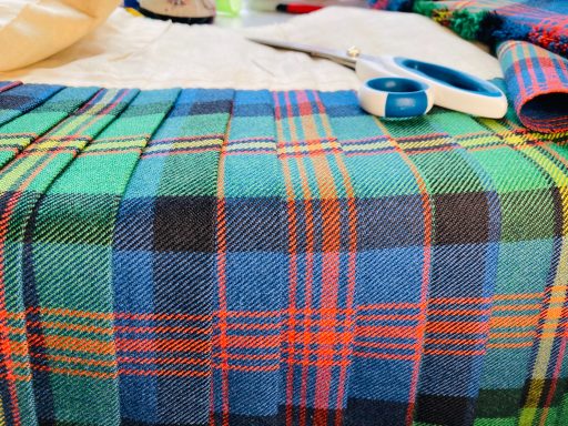 Kilt Waist Adjustments In Progress Open kilt on the table during major waist adjustment.